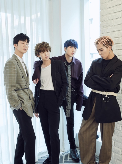 This photo provided by YG Entertainment shows members of K-pop band WINNER posing for photos during a group media interview for their latest album, "EVERYD4Y," on April 4, 2018, in Seoul.