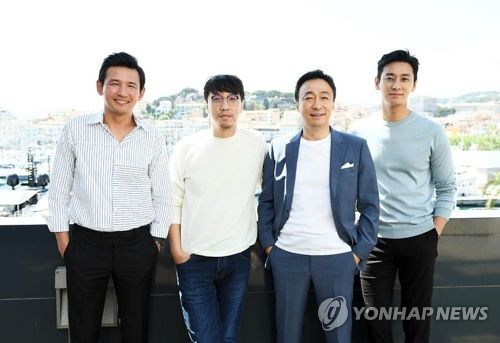 In this file photo provided by CJ E&M, director Yoon Jong-bin (2nd from L), and cast members of Yoon's latest film "The Spy Gone North" pose for photographers during the 71st Cannes Film Festival in Cannes, France, on May 14, 2018. (Yonhap)