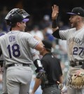 In this Associated Press photo, Oh Seung-hwan of the Colorado Rockies (L) celebrates his save with shortstop Trevor Story after beating the Milwaukee Brewers 5-4 in a Major League Baseball regular season game at Miller Park in Milwaukee on Aug. 5, 2018. It was Oh's first save for the Rockies since arriving in a trade from the Toronto Blue Jays on July 26, 2018. (Yonhap)
