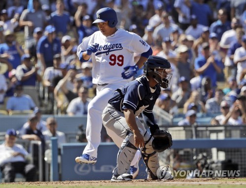 In this Associated Press photo, Los Angeles Dodgers' Ryu Hyun-jin (L) scores past San Diego Padres catcher Francisco Mejia after a single by David Freese during the fourth inning of a Major League Baseball regular season game at Dodger Stadium in Los Angeles on Sept. 23, 2018. (Yonhap)