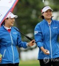 Ryu So-yeon (L) and Chun In-gee are all smiles after completing the second hole during the second round of the UL International Crown at Jack Nicklaus Golf Club Korea in Incheon, 40 kilometers west of Seoul, on Oct. 5, 2018, in this photo provided by the tournament organizers. (Yonhap)