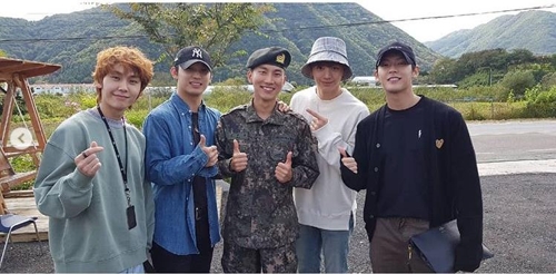 This recent image captured from BTOB's Instagram account shows members visiting the military unit where Seo Eun-kwang is serving his mandatory military service. (Yonhap)