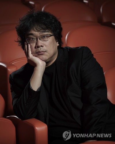 This Oct. 8, 2019 photo shows filmmaker Bong Joon-Ho posing for a portrait at the Whitby Hotel screening room in New York to promote his film "Parasite." The film will open in theaters Friday having already amassed $70.9 million in Bong's native South Korea. In May, "Parasite" won the Palme d’Or at the Cannes Film Festival, a first for a Korean film. (Photo by Christopher Smith/Invision/AP)