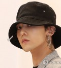 South Korean retail giant Shinsegae Group on Tuesday denied a rumor that G-Dragon of K-pop band BIGBANG was romantically involved with the granddaughter of the group's chairperson. Speculation surrounding G-Dragon, whose real name is Kwon Ji-yong, and the granddaughter of Chairperson Lee Myung-hee first emerged after a Chinese entertainment media outlet alleged that the two recently attended a concert together. "It is absolutely not true," a Shinsegae official said of the dating rumor. "We are offering an official statement to correct the wrong information following a string of indiscriminate and speculative reports," the official said. The official said the two recently went to a concert together but as part of a larger group and that the granddaughter shared a photo but "only as a fan of the singer." The official asked the media to refrain from further speculative reporting. G-Dragon, who made his debut as the leader of quintet group BIGBANG in 2006, is in talks with YG Entertainment to decide whether to remain with the agency as a solo artist. The other members have terminated their contracts with the agency. This file photo shows South Korean rapper G-Dragon at a publicity event in Seoul on May 1, 2017, for the apparel brand 8seconds. (Yonhap) This file photo shows South Korean rapper G-Dragon at a publicity event in Seoul on May 1, 2017, for the apparel brand 8seconds. (Yonhap)