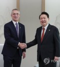 South Korean President Yoon Suk Yeol (R) and North Atlantic Treaty Organization Secretary General Jens Stoltenberg pose for a photo during their meeting at the presidential office in Seoul on Jan. 30, 2023, in this photo provided by the office. (PHOTO NOT FOR SALE) (Yonhap)