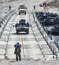Military vehicles cross a makeshift bridge assembled by South Korean and U.S. troops during combined river-crossing drills at a training ground in the border county of Yeoncheon, 62 kilometers of Seoul, in this photo provided by the South's Army on March 15, 2023. The drills kicked off on March 6 and will run until March 17. (PHOTO NOT FOR SALE) (Yonhap)