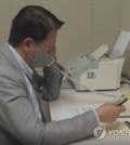 This file photo, provided by the unification ministry, shows a South Korean liaison officer talking to his North Korean counterpart at the Seoul bureau of their joint liaison office on Oct. 4, 2021. (PHOTO NOT FOR SALE) (Yonhap)