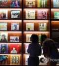 Visitors look at LP records on display at an exhibition, titled "The Pop Culture We Loved, and Rise of the Korean Wave," at the National Museum of Korean Contemporary History in Seoul on July 20, 2023. (Yonhap)