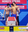 South Korean swimmers Hwang Sun-woo, Kim Woo-min and Yang Jae-hoon (L to R) celebrate after teammate Lee Ho-joon (in water) completed the final leg of the men's 4x200-meter freestyle relay for the national record time of 7:04.07 in the final at the World Aquatics Championships at Marine Messe Fukuoka Hall A in Fukuoka, Japan, on July 28, 2023. (Yonhap)