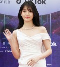 Singer-actor IU poses for photos during a red carpet event for the 59th Baeksang Arts Awards held at a hotel in Incheon, 30 kilometers west of Seoul, on April 28, 2023. (Yonhap)