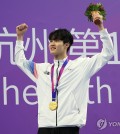 South Korean swimmer Hwang Sun-woo poses with his gold medal won in the men's 200-meter freestyle at the Asian Games at Hangzhou Olympic Sports Centre Aquatic Sports Arena in Hangzhou, China, on Sept. 27, 2023. (Yonhap)