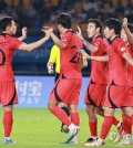Cho Young-wook of South Korea (L) celebrates with teammates after scoring against Kyrgyzstan during the round of 16 match in the men's football tournament at the Asian Games at Jinhua Sports Centre Stadium in Jinhua, China, on Sept. 27, 2023. (Yonhap)