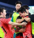 Jeong Woo-yeong of South Korea (2nd from R) is mobbed by teammates after scoring against Uzbekistan during the teams' semifinals match of the men's football tournament at Huanglong Sports Centre Stadium in Hangzhou, China, on Oct. 4, 2023. (Yonhap)