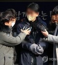 The suspect in the stabbing attack on Lee Jae-myung (C), the chair of the main opposition Democratic Party, speaks to reporters at a police station in Busan on Jan. 10, 2024, as he is being transported to the prosecution. (Yonhap)