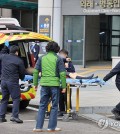 An emergency patient is carted from an ambulance to be admitted to a general hospital in Seoul on Feb. 25, 2024. (Yonhap)