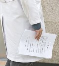 This photo taken Feb. 19, 2024, shows a resident doctor carrying his letter of resignation at a university hospital in Daegu, 237 kilometers south of Seoul, in protest of the government's plan to increase the number of medical school admissions by 2,000, starting from 2025. (Yonhap)