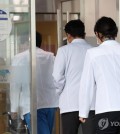 Medical workers enter the Seoul National University Hospital in central Seoul on March 11, 2024. (Yonhap)