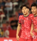 Lee Kang-in (L) and Son Heung-min celebrate Son's goal against Thailand during the teams' Group C match in the second round of the Asian World Cup qualification tournament at Rajamangala Stadium in Bangkok on March 26, 2024. (Yonhap)