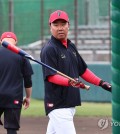 In this file photo from Feb. 24, 2024, Kia Tigers manager Lee Bum-ho watches his players during spring training at Kin Town Baseball Stadium in Kin, Japan. (Yonhap)