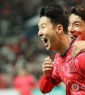 Son Heung-min of South Korea (L) celebrates after scoring against Thailand during the teams' Group C match in the second round of the Asian World Cup qualification tournament at Seoul World Cup Stadium in Seoul on March 21, 2024. (Yonhap)