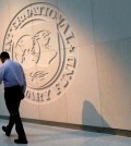 A man walks past the International Monetary Fund (IMF) logo at its headquarters in Washington, U.S., May 10, 2018. REUTERS/Yuri Gripas