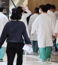 Medical workers walk inside a large general hospital in Seoul on April 17, 2024. (Yonhap)