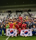 In this photo provided by the Korea Football Association, South Korean players and coaches celebrate their 1-0 win over Japan in their Group B match at the Asian Football Confederation U-23 Asian Cup at Jassim bin Hamad Stadium in Al Rayyan, Qatar, on April 22, 2024. (PHOTO NOT FOR SALE) (Yonhap)