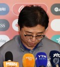 Hwang Sun-hong, head coach of the South Korean men's under-23 national football team, hangs his head before speaking to reporters at Incheon International Airport, west of Seoul, on April 27, 2024. South Korea lost to Indonesia in the quarterfinals of the Asian Football Confederation U-23 Asian Cup to miss out on qualification for the Paris Olympics. (Yonhap)