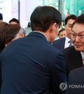 President Yoon Suk Yeol greets Cho Kuk, leader of the minor opposition Rebuilding Korea Party, during an event marking Buddha's birthday at Jogye Temple in central Seoul on May 15, 2024. (Yonhap)