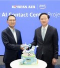 This photo taken May 20, 2024, shows Korean Air President Woo Kee-hong (R) shaking hands with Ham Kee-ho, CEO of AWS Korea, after signing a deal to develop a Korean Air AI Contact Center (AICC) platform at the Korean carrier's headquarters in Seoul. (PHOTO NOT FOR SALE) (Yonhap)