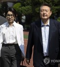 In this file photo, former President Yoon Suk Yeol (R) and first lady Kim Keon Hee head to their vehicle after casting their votes at a polling station in Seoul on June 3, 2025. (Pool photo) (Yonhap)
