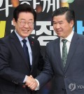 In this Dec. 16, 2024, file photo, Lee Jae-myung (L), leader of the Democratic Party, shakes hands with James Kim, chairman of the American Chamber of Commerce in Korea, at a meeting held at the National Assembly in Seoul. (Yonhap)