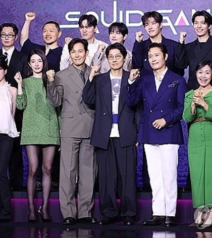 Cast members and director Hwang Dong-hyuk (C, 1st row) pose for photos during a press conference in Seoul on June 9, 2025. (Yonhap)
