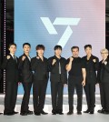 Brian Chesky (6th from R), co-founder and CEO of Airbnb, poses with K-pop boy group Seventeen during a photo session to mark the launch of the "Seventeen Airbnb Experience" in Seoul on June 4, 2025. (Yonhap)